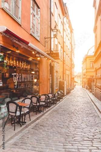  Narrow street with cafe in with beautiful sky.