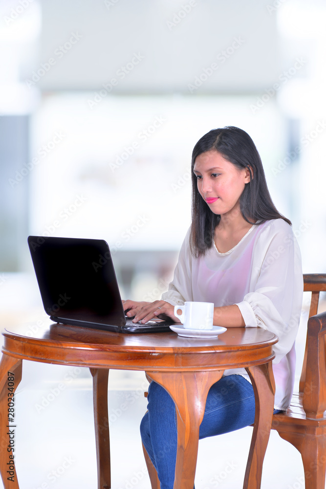 Young pretty business woman with notebook in office Young pretty business woman with notebook in office