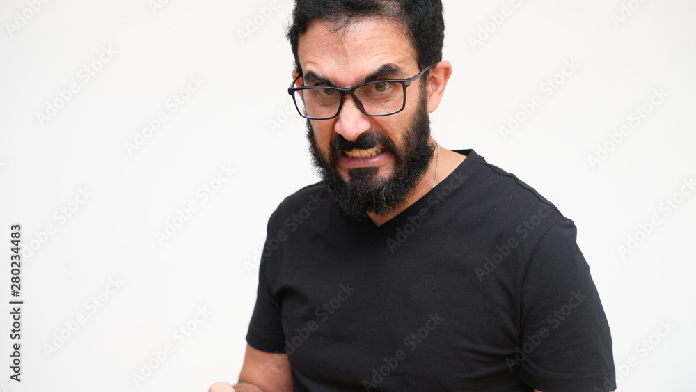 Fototapeta premium middle age bearded man in a white backround making an angry expression