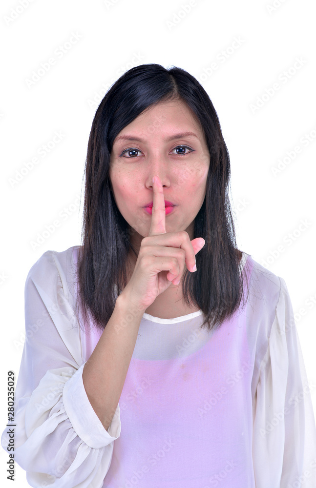 Portrait of attractive teenage girl with finger on lips, isolated over white background concept of student show quiet, silence, secret gesture, young pretty brunette woman Portrait of attractive teenage girl with finger on lips, isolated over white background concept of student show quiet, silence, secret gesture, young pretty brunette woman