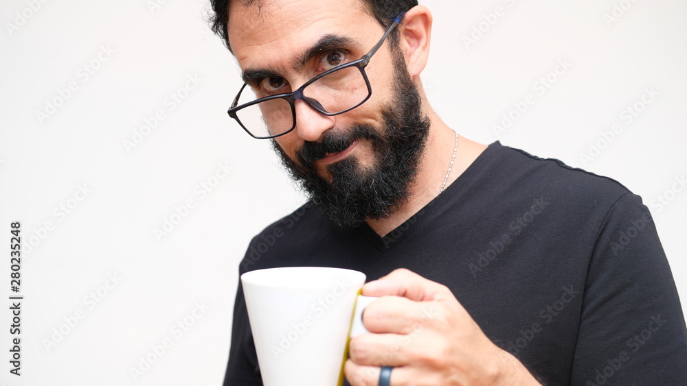 Middle age man in a white backround holding a cup of coffee Middle age man in a white backround holding a cup of coffee