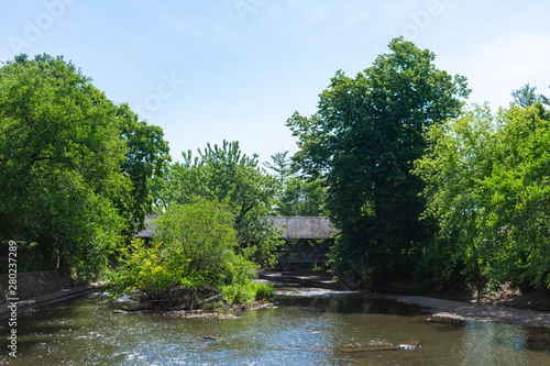 Covered Bridge with Trees along the Naperville Riverwalk over the DuPage River