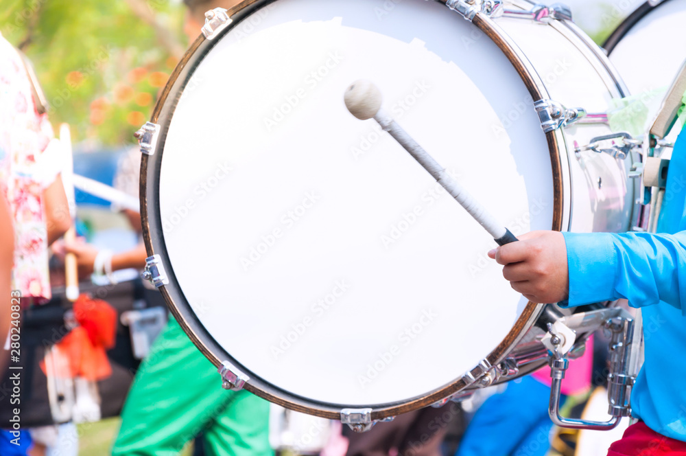 Drummer in blue uniforms a Marching Band. Drummer plays big drum in parade  Photos | Adobe Stock