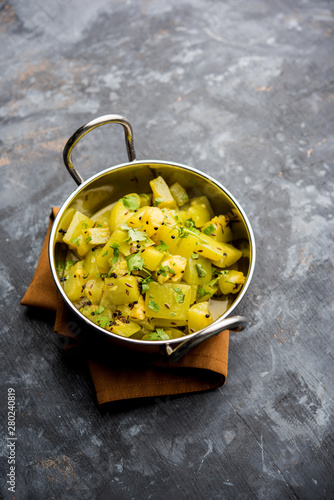 Lauki/doodhi ki sookhi Sabji also known as bottle gourd dry vegetable recipe. served in a bowl or karahi. selective focus photo