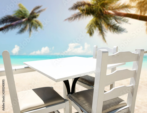 Table background on a beautiful ocean and sandy beach view in distance.