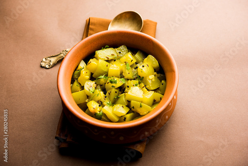 Lauki/doodhi ki sookhi Sabji also known as bottle gourd dry vegetable recipe. served in a bowl or karahi. selective focus photo