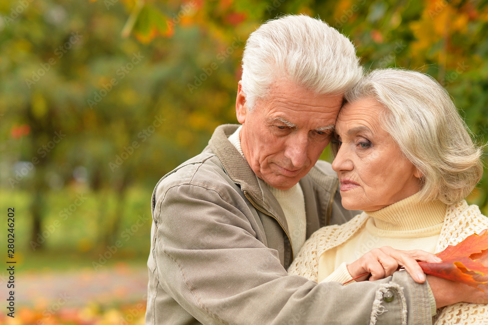 Portrait of sad senior couple in autumn park Portrait of sad senior couple in autumn park