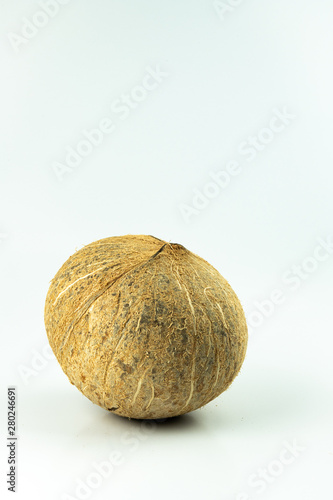 Closeup coconut of organic tropical fruit  hard white large nut with hollow center filled with milky juice  popular fruit use for Thai cooking and many kind of dessert isolated on white background.