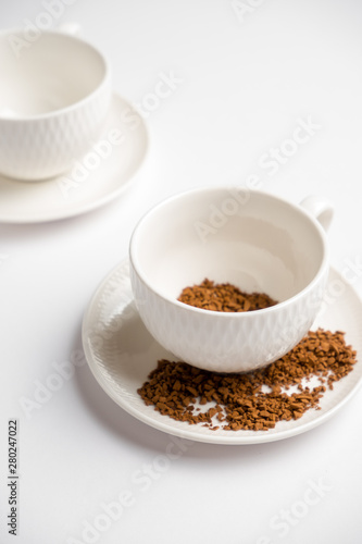 white coffee cups with instant coffee on a white background