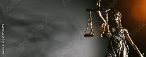Statue of lady justice on bright background - Side view with copy space. photo