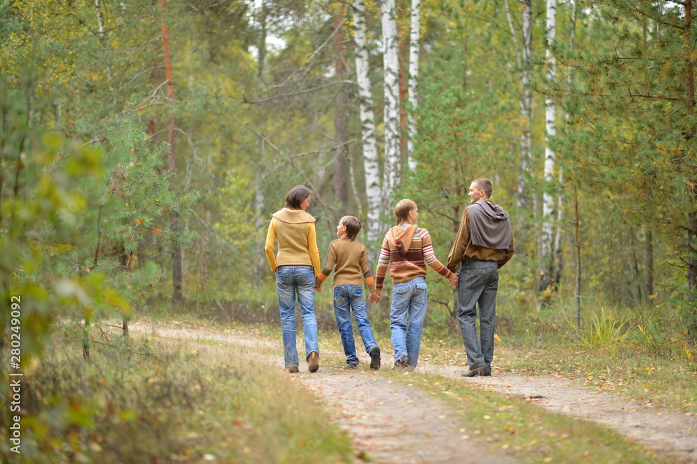 Portrait of family of four in park