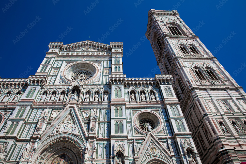 Fototapeta premium The Giotto Campanile and Florence Cathedral consecrated in 1436 against a beautiful blue sky