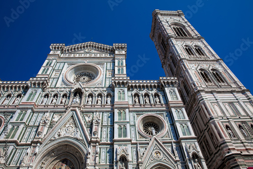 The Giotto Campanile and Florence Cathedral consecrated in 1436 against a beautiful blue sky photo