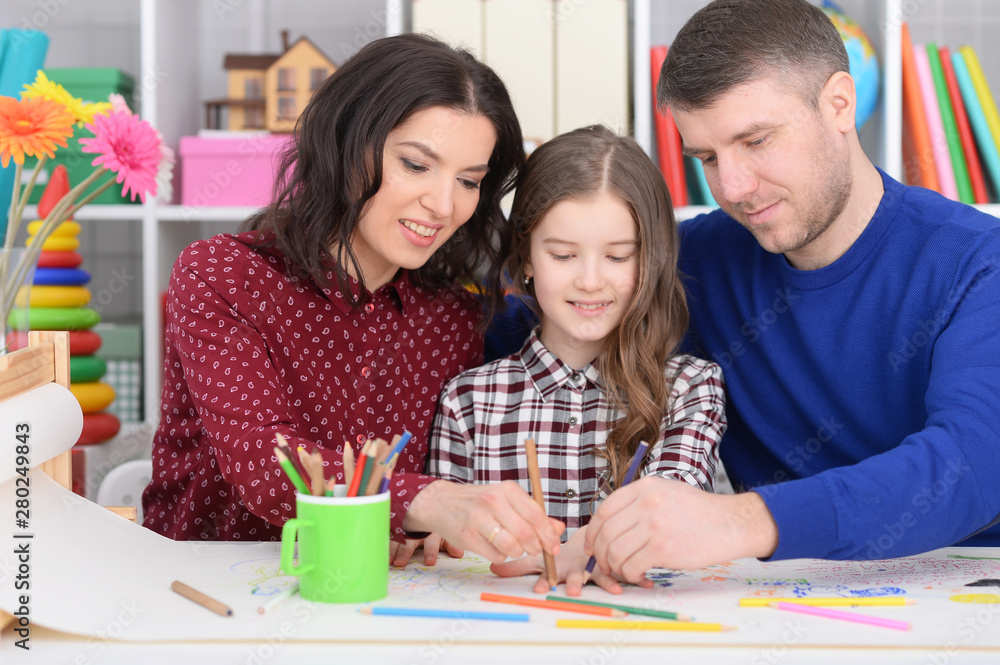 Portrait of parents and daughter doing homework Portrait of parents and daughter doing homework