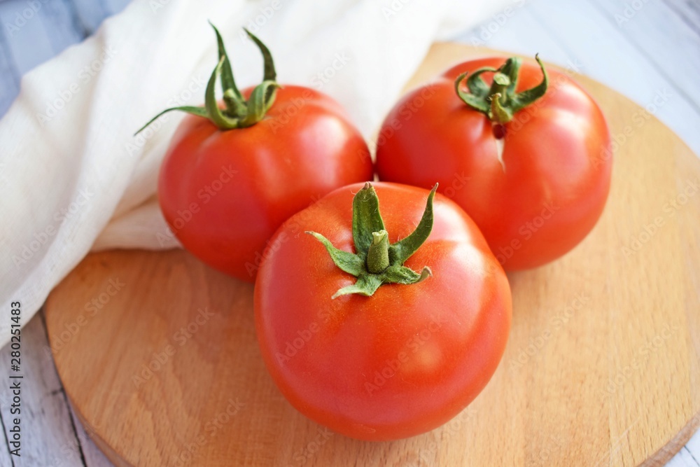Delicious,ripe tomatoes on a wooden background.Healthy diet.