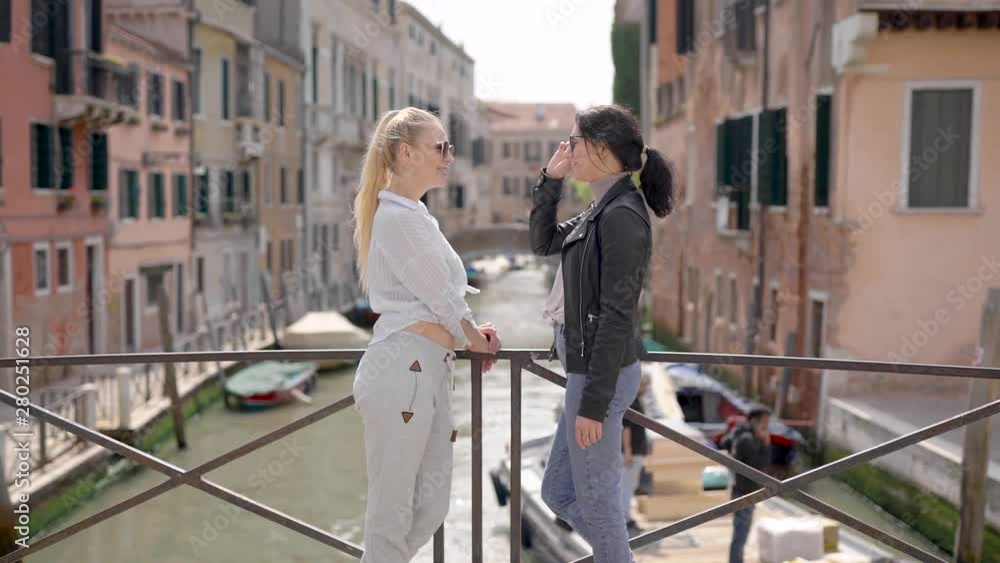 Friends travel around Venice. The famous city in Italy attracts with its streets and cafes, as well as the ancient architecture. Friends travel around Venice. The famous city in Italy attracts with its streets and cafes, as well as the ancient architecture.