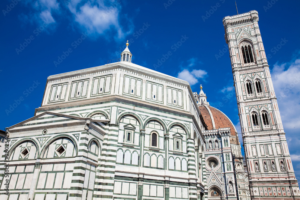 Baptistery of St. John, Giotto Campanile and Florence Cathedral consecrated in 1436 against a beautiful blue sky