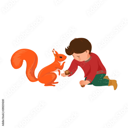 Cute kid boy give to colorful red squirrel nut