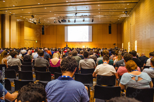 Huge audience listening to a scientific presentation in an European conference