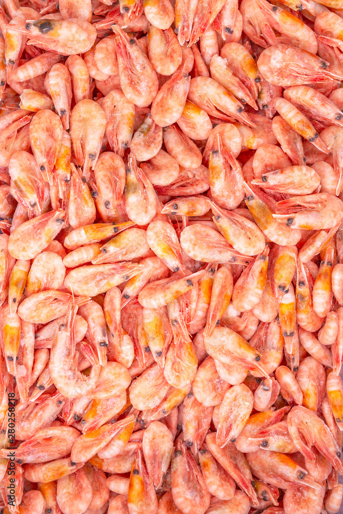 Frozen king prawns in a supermarket. Close-up. Vertical. Space for text. Frozen king prawns in a supermarket. Close-up. Vertical. Space for text.