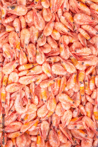Frozen king prawns in a supermarket. Close-up. Vertical. Space for text. © Анна Демидова
