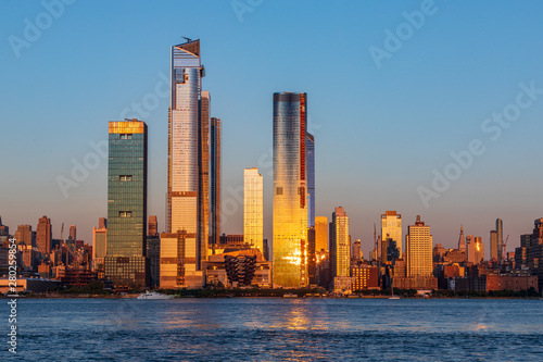 View to Manhattan skyline from Weehawken Waterfront in  Hudson River at sunset. photo