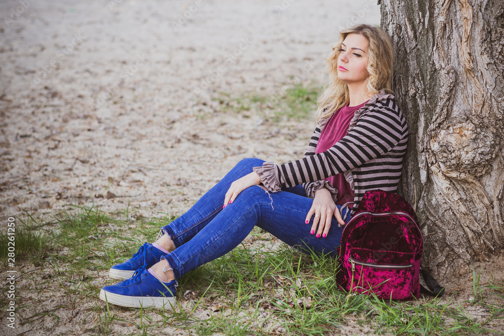 Nice European or American plump girl at park, concept of modern women lifestyle, walk in autumn time Nice European or American plump girl at park, concept of modern women lifestyle, walk in autumn time