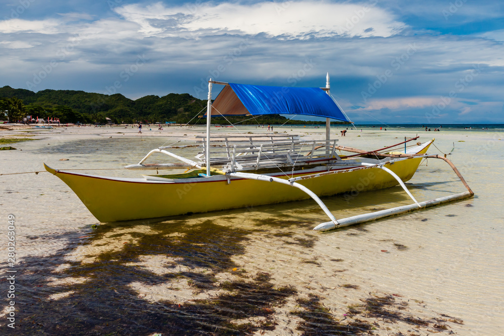 Small wooden boats on a tropical beach in the Philippines