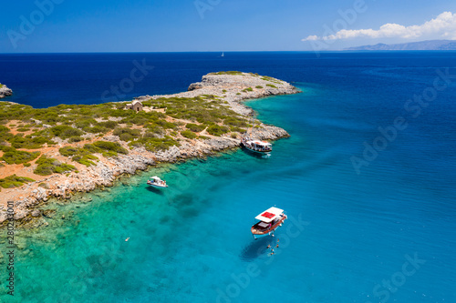 Aerial view of swimmiers and snorkellers in a hot, crystal clear ocean (Crete, Greece)