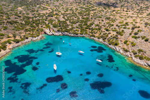 Aerial drone view of traditional Greek wooden boats floating on the crystal clear waters of the Aegean Sea  Crete 