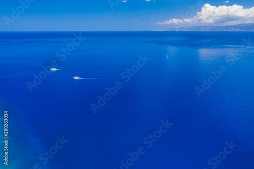 Aerial drone view of traditional Greek wooden boats floating on the crystal clear waters of the Aegean Sea (Crete)