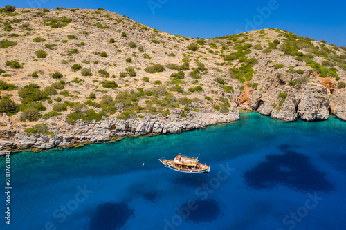 Fototapeta Naklejka Na Ścianę i Meble -  Aerial view of swimmiers and snorkellers in a hot, crystal clear ocean (Crete, Greece)