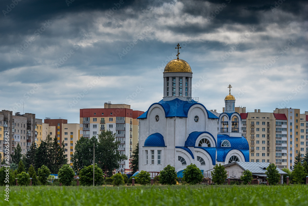 A small church in the city. Photographed in cloudy weather.