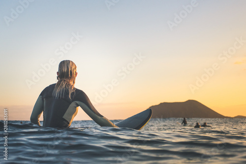 Rear view of woman surfing in sea photo