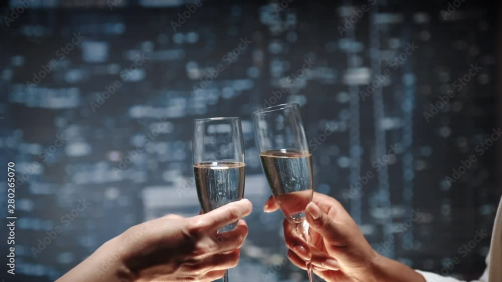 Close up of two hands with bocals of champagne making cheers and then drinking. Celebration of business success. Close up of two hands with bocals of champagne making cheers and then drinking. Celebration of business success.