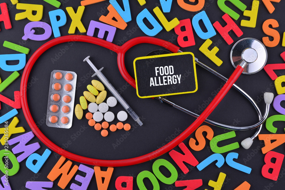 Pills, Syringe and Stethoscope with alphabet and text Food Allergy