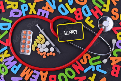 Pills, Syringe and Stethoscope with alphabet and text Allergy