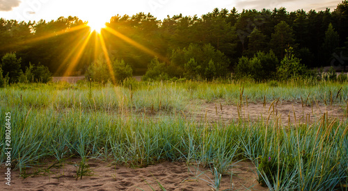 Sandy beach and sunset at the bay photo