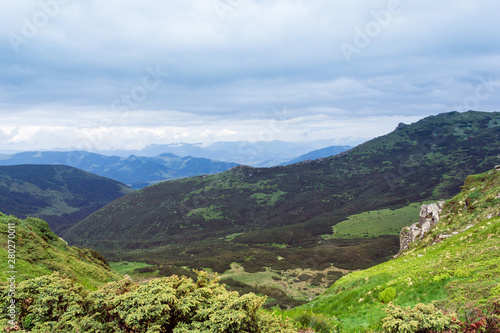 landscape of a Carpathians mountains with grassy valley and sky