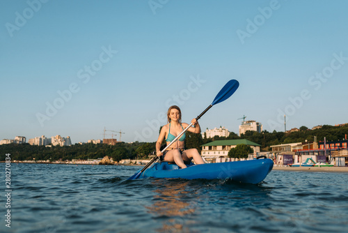 active lifestyle, girl athlete kayaking early in the morning