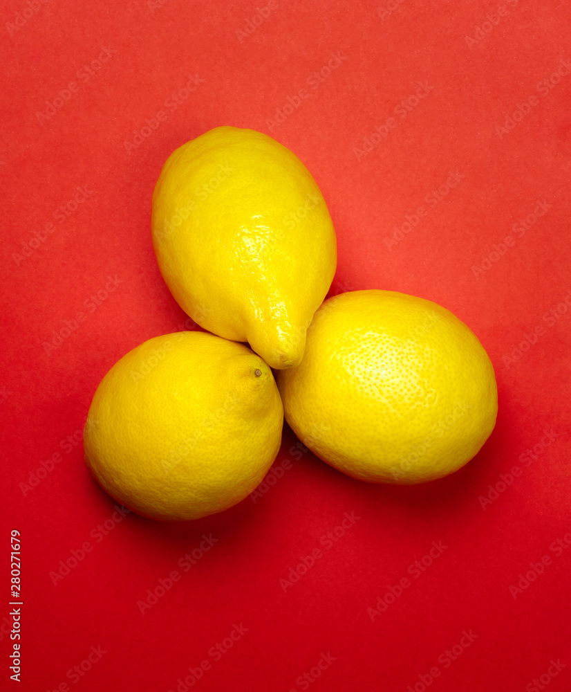 YELLOW LEMONS ON RED BACKGROUND YELLOW LEMONS ON RED BACKGROUND