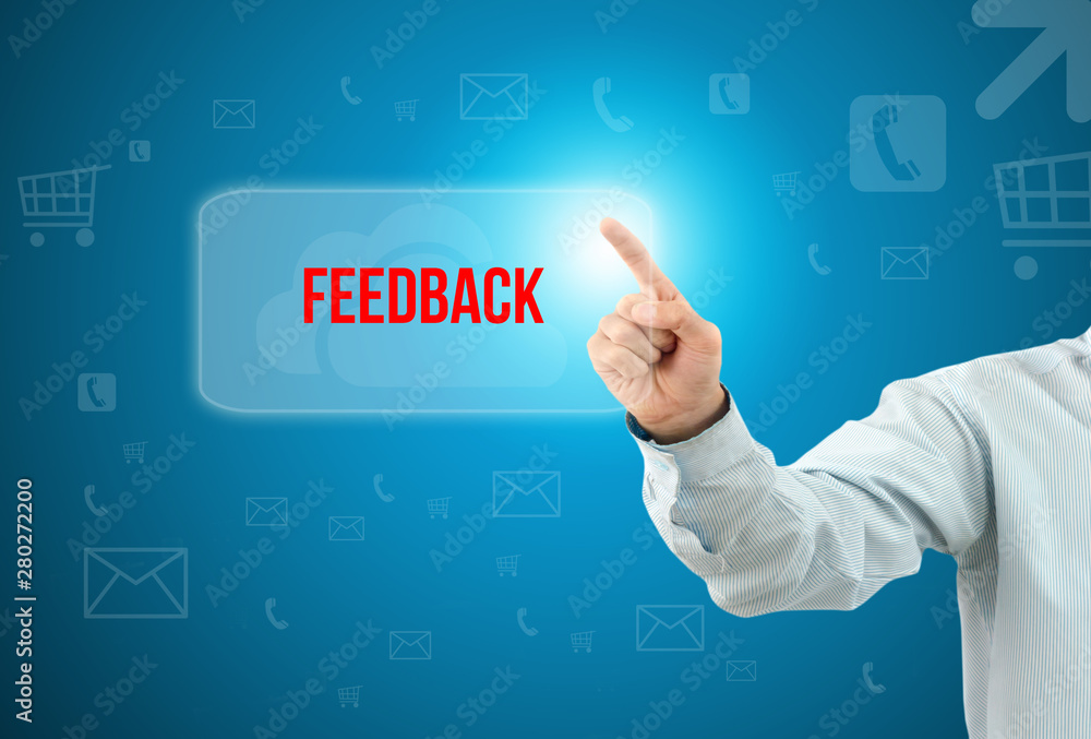Business man touch a button on an imaginary screen with text FEEDBACK Business man touch a button on an imaginary screen with text FEEDBACK