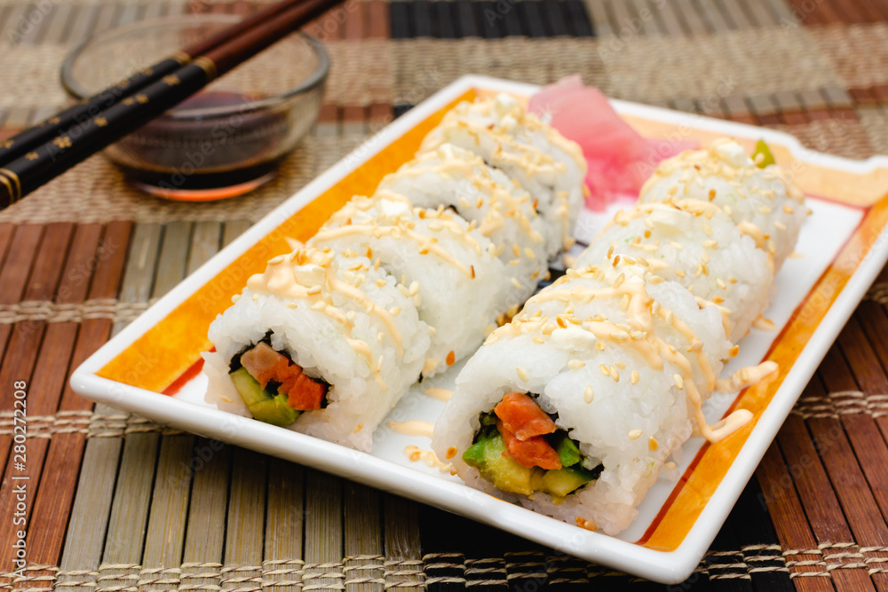 Homemade sushi rolls with salmon and cucumber. Homemade sushi rolls with salmon and cucumber.