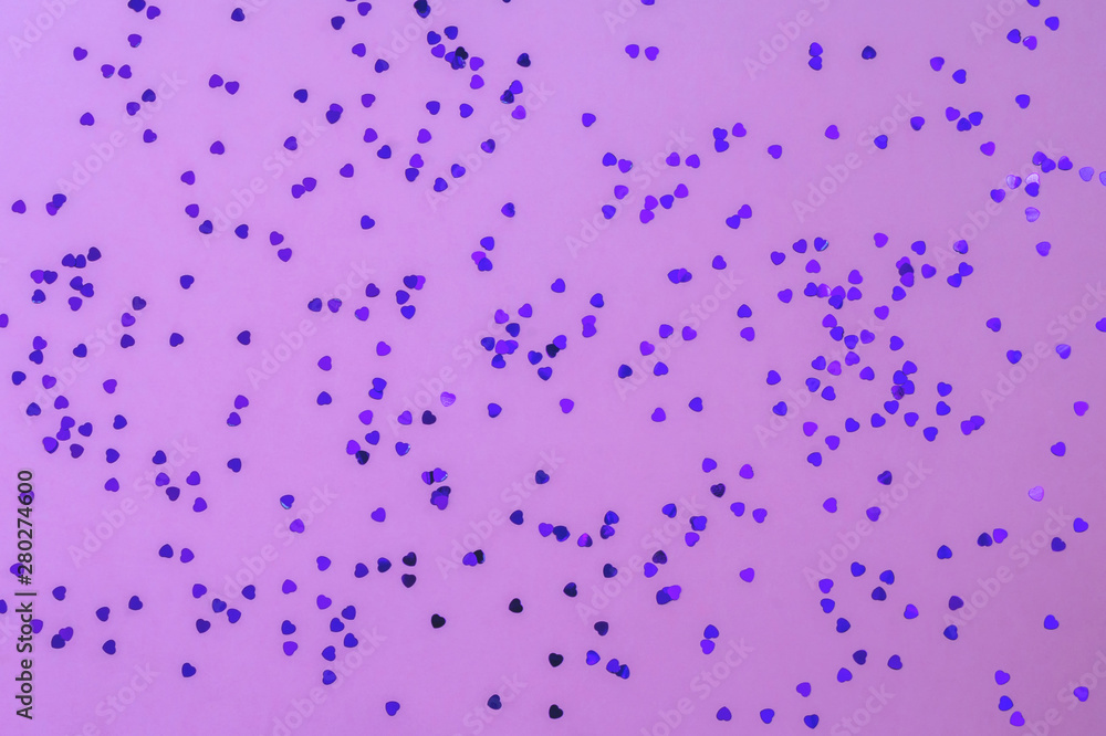 Purple color glitter in heart shape on violet background. Festive background. Suitable for christmas, new year, chinese new year and your designs Purple color glitter in heart shape on violet background. Festive background. Suitable for christmas, new year, chinese new year and your designs