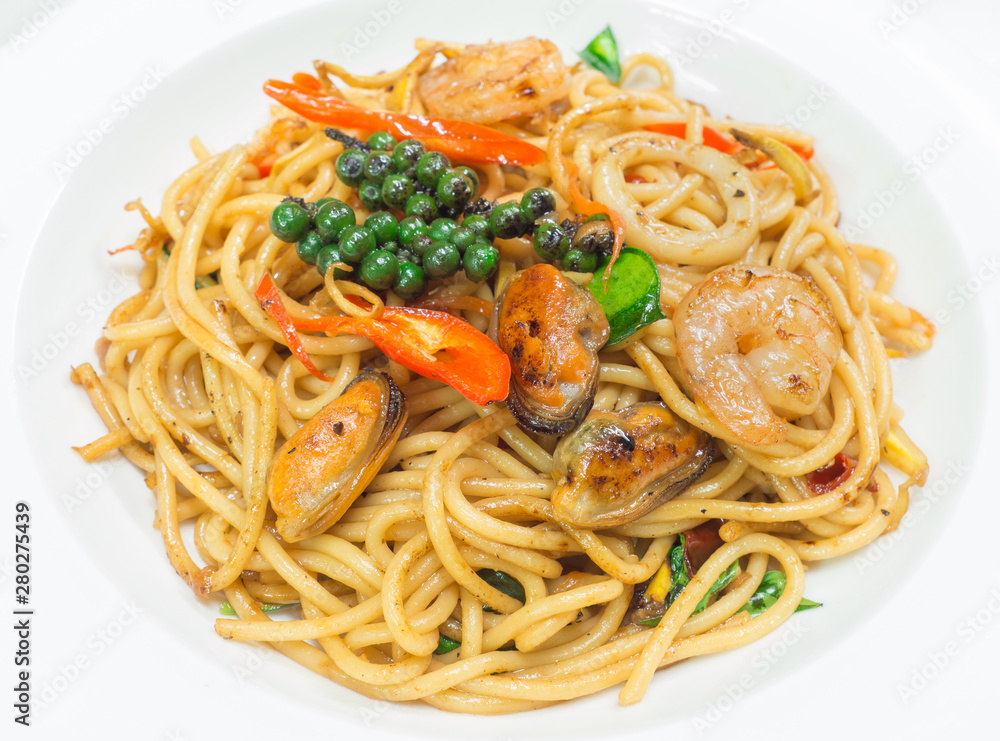 Spaghetti spicy with seafood on a white plate Spaghetti spicy with seafood on a white plate