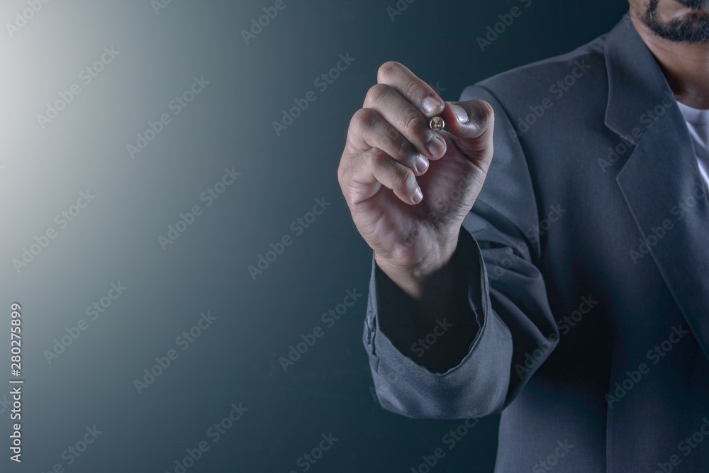 Fototapeta premium Hand of business man write or writing on the virtual touch screen
