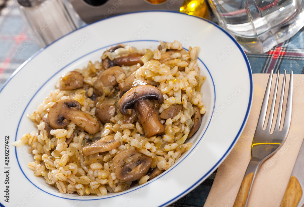 Appetizing barley porridge with mushrooms