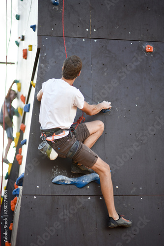 Man with arms wide concentrate and prepare to wall climbing