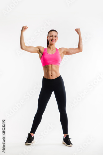Strong girl with perfect abs, shoulders, biceps, triceps and chest.