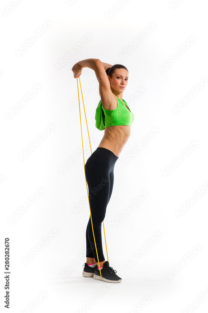 Fitness girl performs exercises with resistance band. Strength and motivation Fitness girl performs exercises with resistance band. Strength and motivation